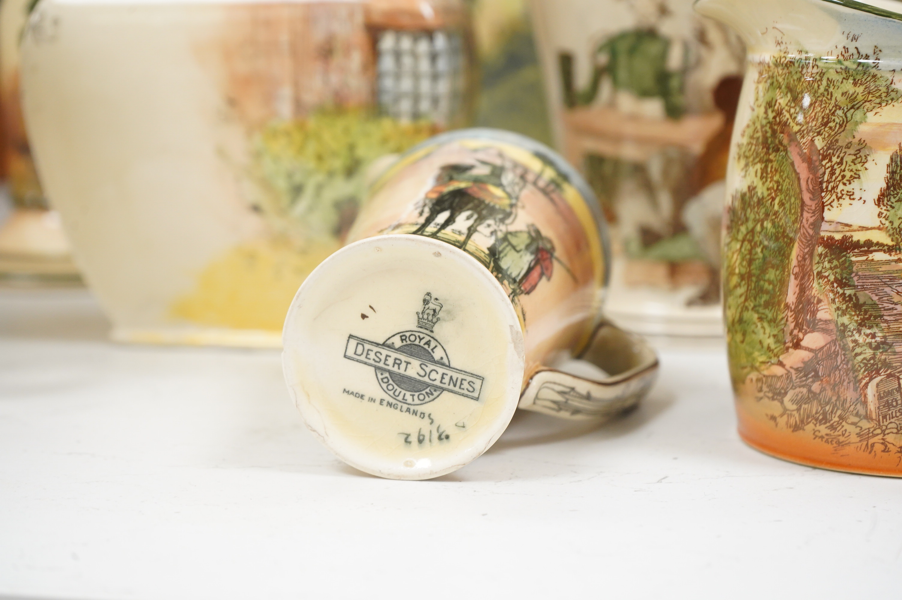 A collection of Royal Doulton series ware jugs, vases and candlesticks, largest 22cm high